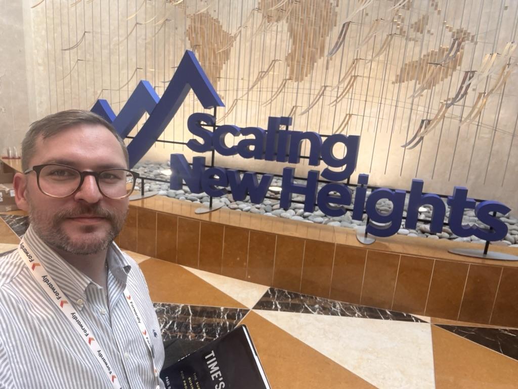 Luke Frye at the Scaling New Heights sign in Orlando